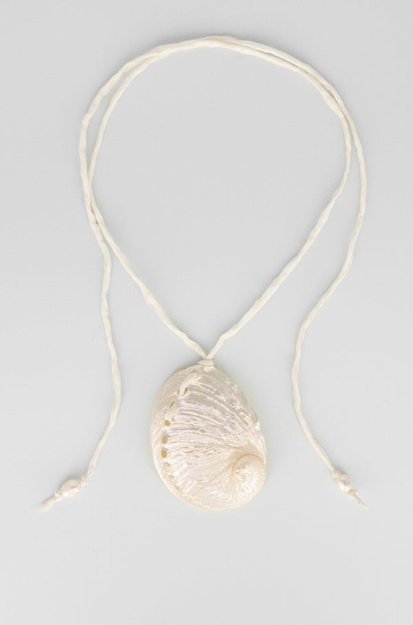 Necklace with a shell pendant on a light gray background