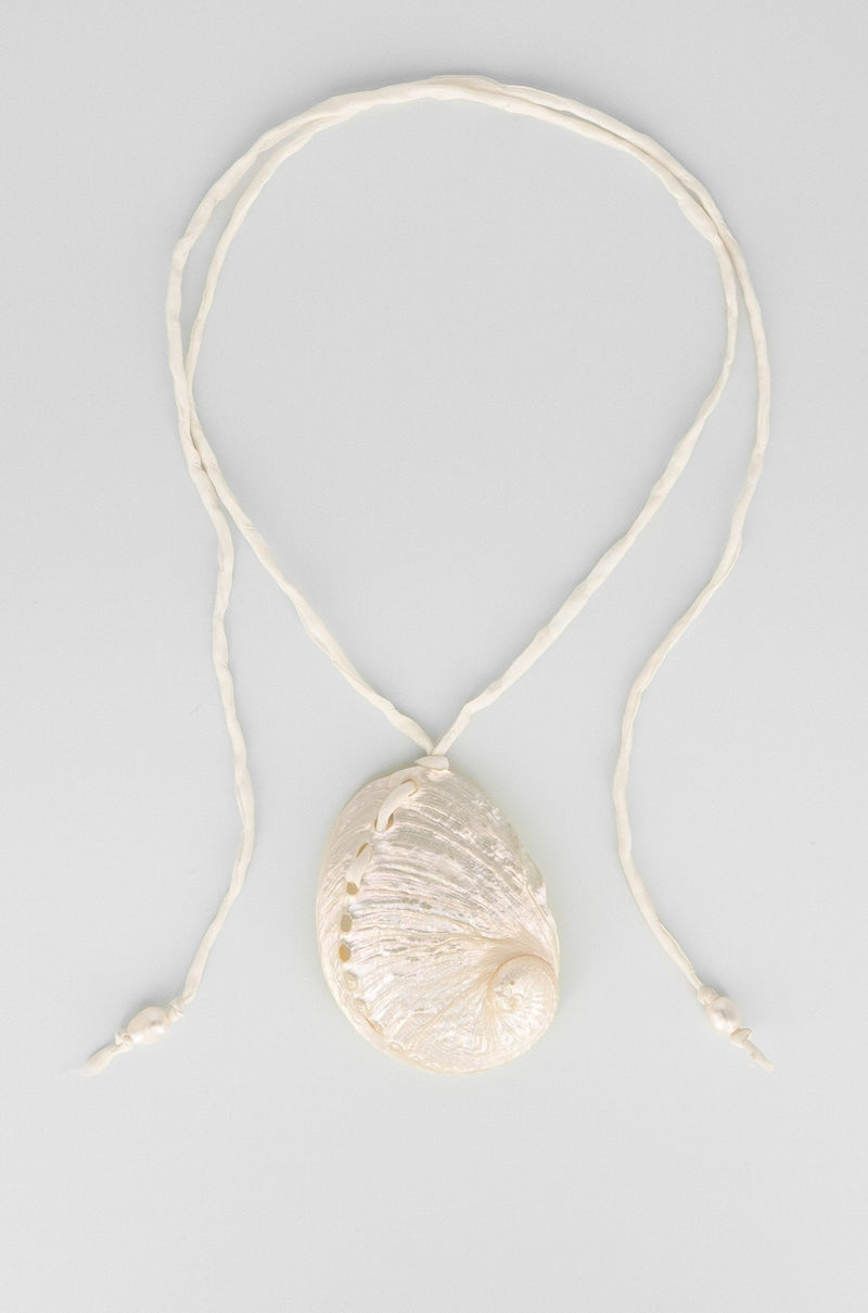 Necklace with a shell pendant on a light gray background