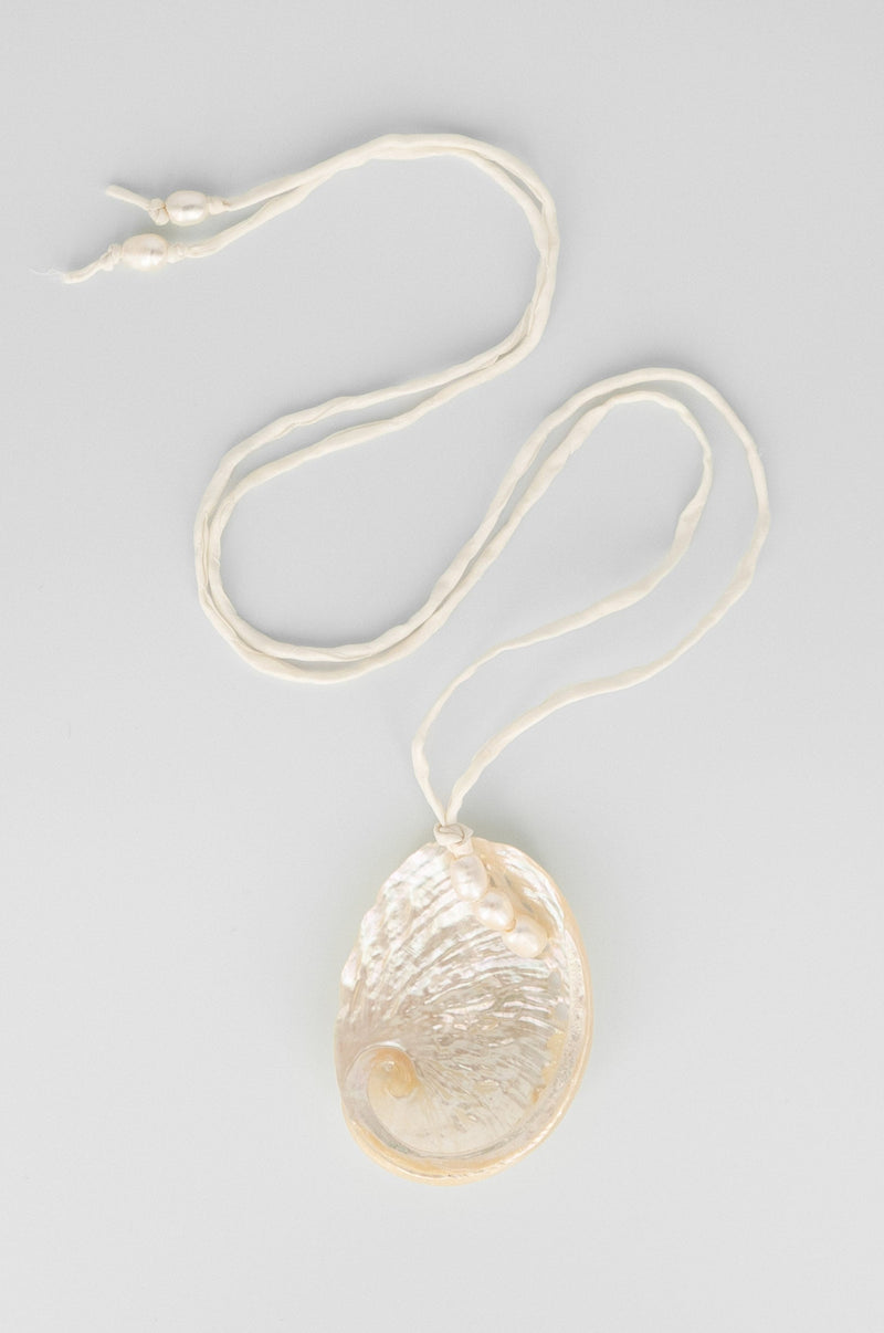 Necklace with a textured pendant on a light gray background