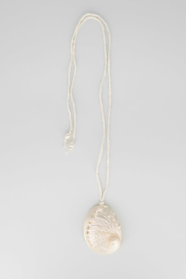 Shell pendant necklace on a gray background
